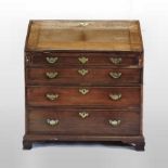 A George III mahogany and crossbanded bureau, having a fitted interior with a sunken well,