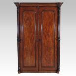 A Victorian mahogany double wardrobe, with a moulded cornice, enclosed by a pair of panelled doors,