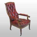 A Regency button back red leather upholstered library armchair, with scrolled carved mahogany arms,