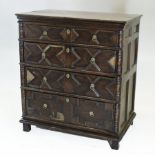 An 18th century oak chest, containing four long geometric moulded drawers,