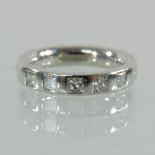 A platinum and diamond set half hoop eternity ring,