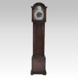 A 1930's oak cased longcase clock, having a brass dial and three train movement,