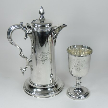 A Victorian silver plated flagon, of tapered shape with a hinged lid and scrolled handle,