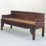 An early 20th century Chinese hardwood bench, with a panelled back,