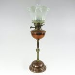 An Arts and Crafts Hinks copper and brass oil lamp, with an opalescent frilled glass shade,