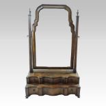 A Queen Anne style walnut serpentine swing frame toiletry mirror, the rectangular adjustable plate,