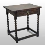 An 18th century oak side table, containing a single frieze drawer, on bobbin turned legs,