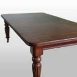 A Victorian mahogany wind-out extending dining table, with two additional leaves, on fluted legs,