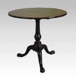 A George III mahogany and satinwood banded occasional table, having a hinged circular top,