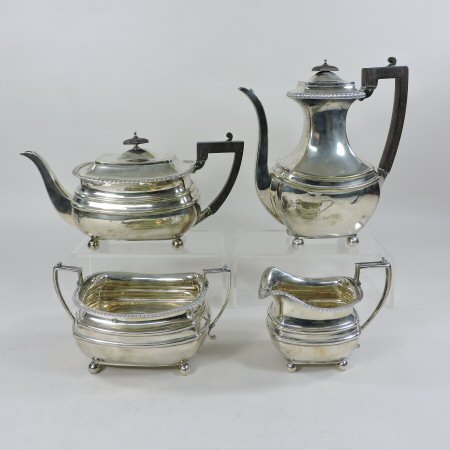 An Edwardian silver four piece tea and coffee service, of rectangular shape, comprising a teapot,