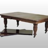 A large Victorian oak wind out extending dining table, on turned legs, with three additional leaves,