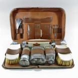 An early 20th century Mappin and Webb leather cased vanity set,