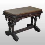 A 19th century heavily carved dark oak centre table, with lion mask decoration,