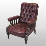 A Victorian red leather upholstered library armchair, with a buttoned back and seat,