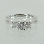 A 14 carat white gold three stone diamond ring, with princess cut stones, approximately 0.