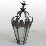 A Venetian style cast iron lantern, decorated with masks and acanthus,