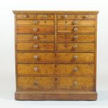 A 19th century stained pine collector's chest, containing an arrangement of fifteen drawers,