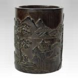 A Chinese carved bamboo brush pot, decorated with an extensive mountain landscape,