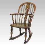 A 19th century elm seated children's rocking chair,