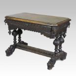 A 19th century heavily carved dark oak centre table, on dolphin feet,