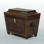 A Regency burr yew tea caddy, of sarcophagus shape, with rosewood and ebony inlay,