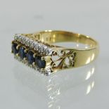 An 18 carat gold sapphire and diamond ring, set with a row of four central sapphires,