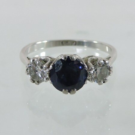 A platinum set sapphire and diamond three stone ring,