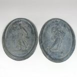 A pair of 19th century lead plaques, each of oval shape, decorated in relief with classical figures,