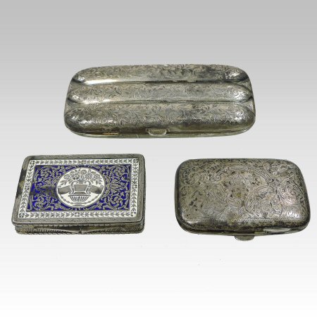 A late Victorian silver cigar case, of hinged form, engraved with scrolling foliate designs,