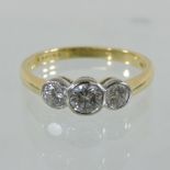 An 18 carat gold and platinum set three stone diamond ring,