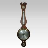 A 19th century mahogany cased wheel barometer, the swan neck pediment centred by an ivory finial,