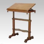 A George IV light oak architect's / library table, having a ratcheted adjustable top,