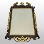 A George III mahogany and parcel gilt fret carved wall mirror, the rectangular bevelled plate,
