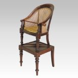 A Regency mahogany child's high chair, with caned back and turned legs,