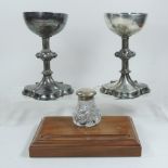 A pair of ornate 19th century silver plated chalices, each having a knopped stem,