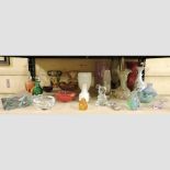 A collection of coloured glass vases and scent bottles