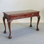 A carved hardwood side table, on cabriole legs, and claw and ball feet,