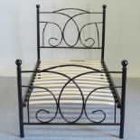 A modern black painted single bedstead,