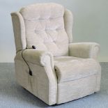A cream upholstered reclining armchair
