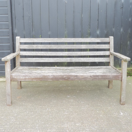 A hardwood slatted wooden garden bench,