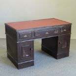 A 1960's Chinese carved pedestal desk, on a plinth base,