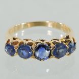 An 18 carat gold and sapphire five stone ring,