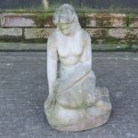 A reconstituted stone garden statue of a lady seated,