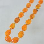An amber coloured bead necklace,
