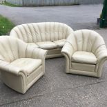 A cream leather upholstered sofa,