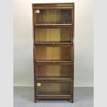 An Angus teak five tier glazed sectional bookcase,