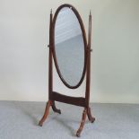 An Edwardian mahogany cheval mirror, having an oval plate, on a splayed base,