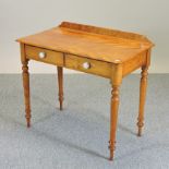 A Victorian satin walnut side table, containing two drawers, on turned legs,