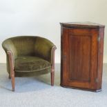 An Edwardian green upholstered tub shaped armchair,