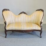 A Victorian carved simulated rosewood and gold upholstered show frame sofa, on cabriole legs,